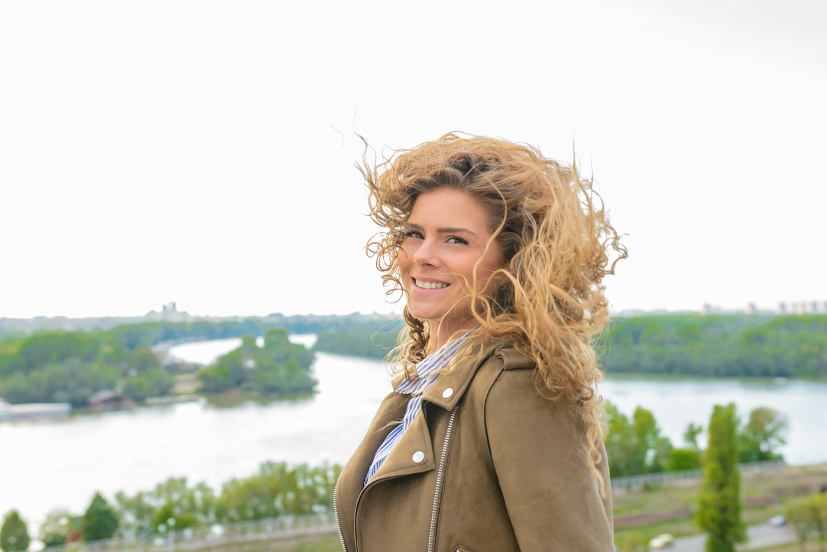 Woman Wearing Brown Coat Smiling